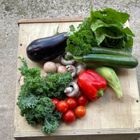 A series of photos showing the Medium Mediterranean Box which contains approximately 6-9 types of veg. May include tomatoes, courgettes, aubergine, peppers, garlic….