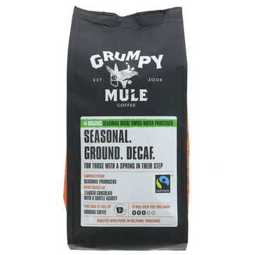 A black bag of ground coffee with a white label