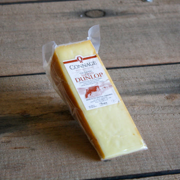 wedge of smoked dunlop scottish organic cheese, vac-packed. made in the scottish highlands