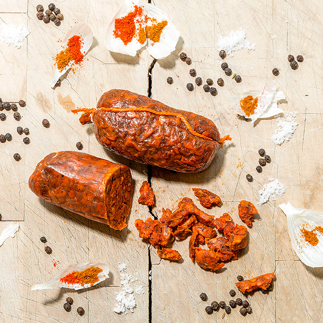 Whiskey-Oak Smoked Nduja surrounded by peppercorns and spices