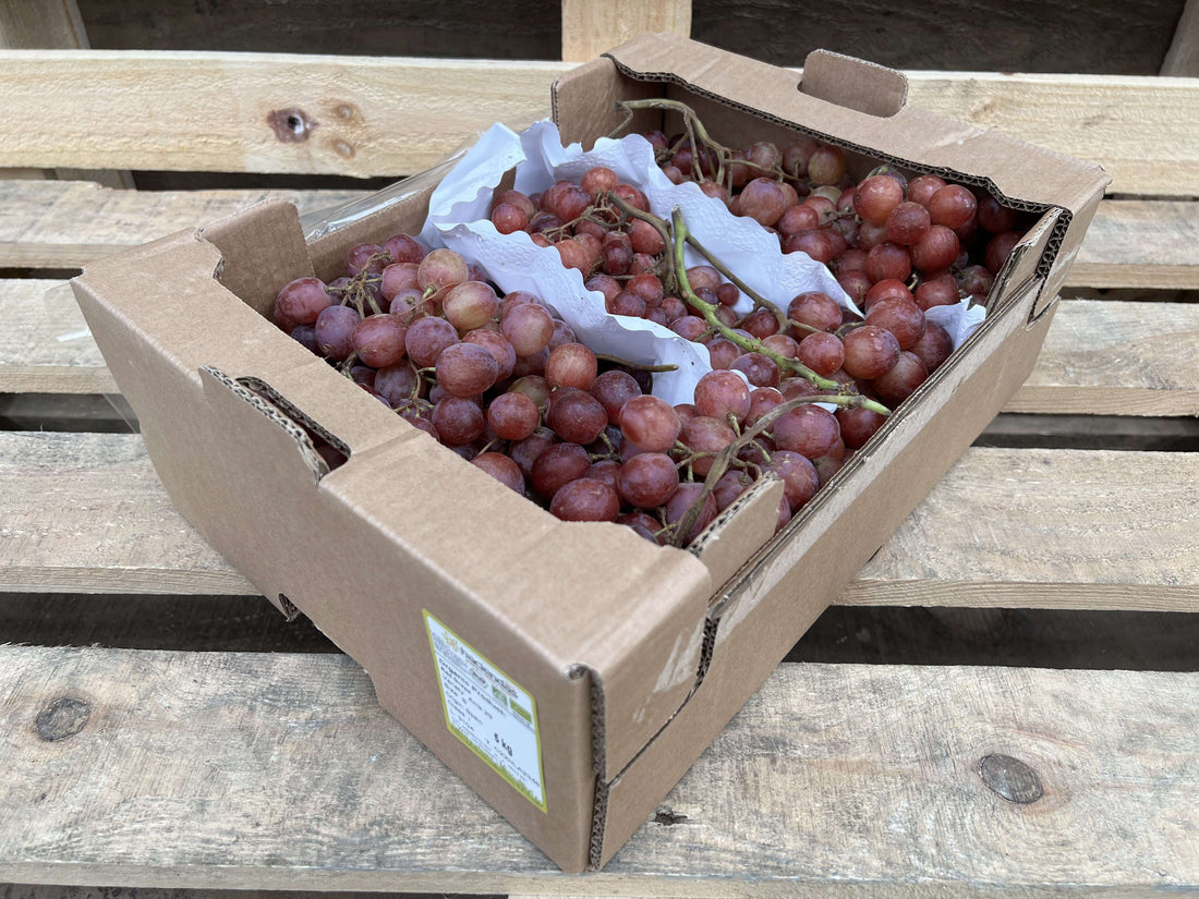 A box of organic red grapes.