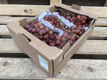A box of organic red grapes.