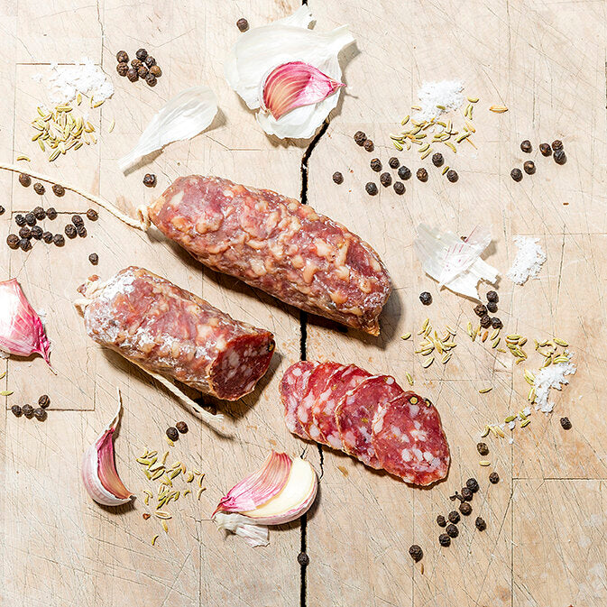 Sliced dried sausage on a chopping board