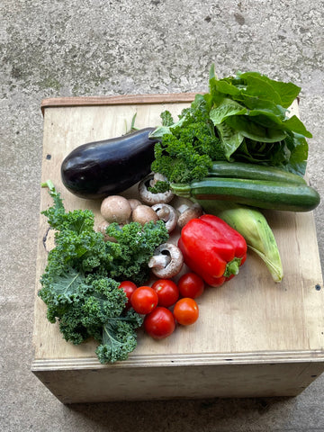 A series of photos showing the Medium Mediterranean Box which contains approximately 6-9 types of veg. May include tomatoes, courgettes, aubergine, peppers, garlic….