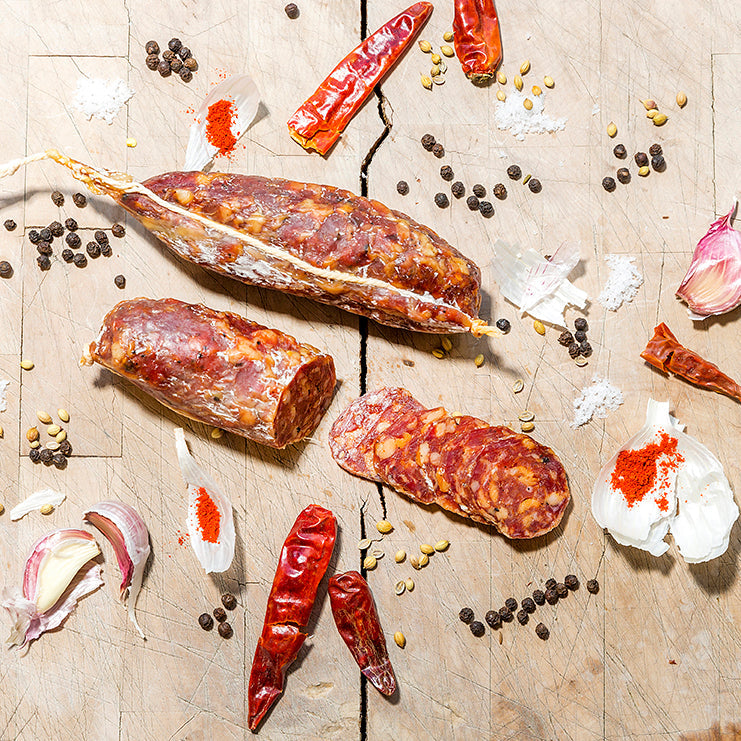 Sliced dried sausage on a chopping board
