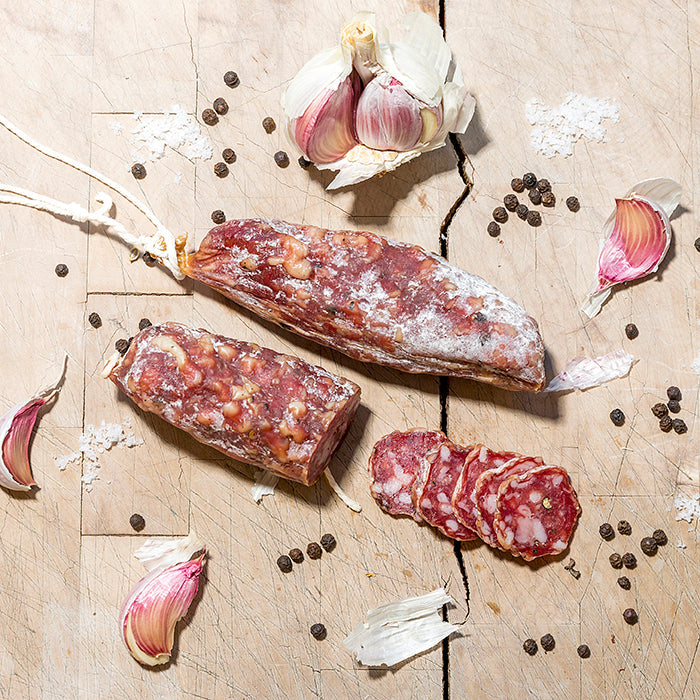 Sliced dried sausage on a chopping board