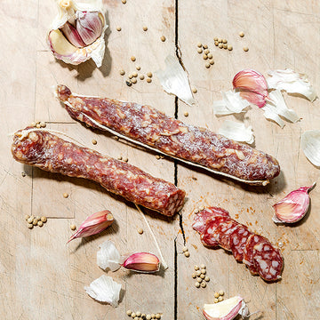 Sliced dried sausage on a chopping board