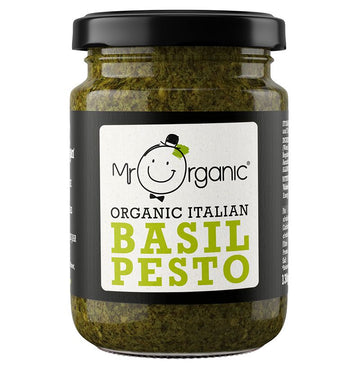 A glass jar of pesto with a metal lid