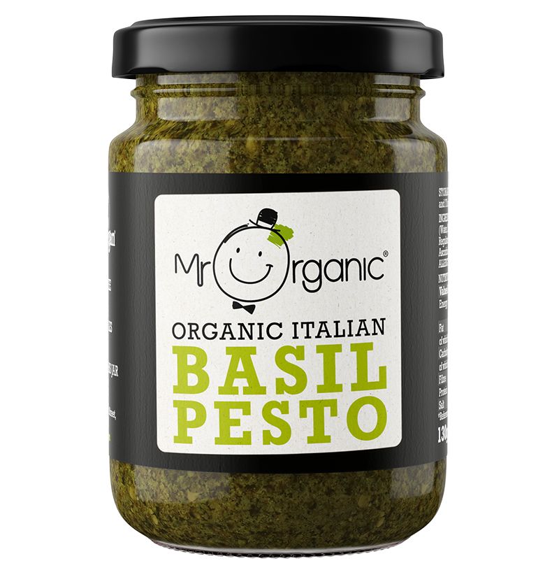 A glass jar of pesto with a metal lid