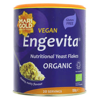 A purple cardboard tub of organic nutritional yeast flake with a plastic lid
